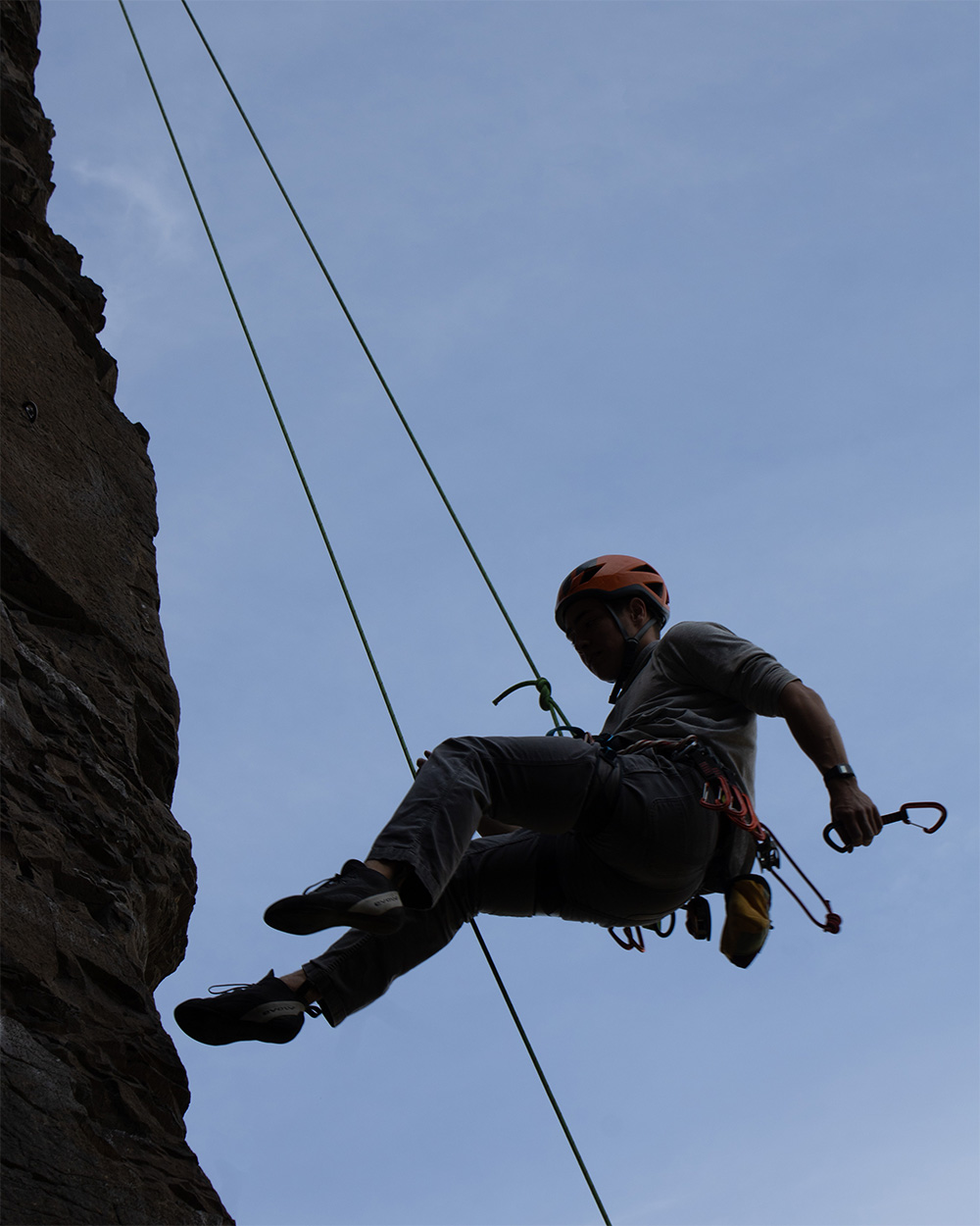 Rock climber coming down after a successful lead climb